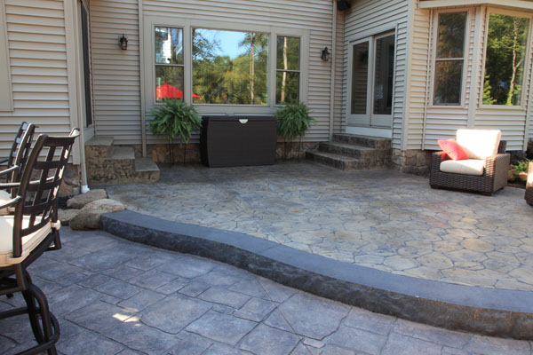 Tiered Stamped Concrete Patios with Rock Face Step